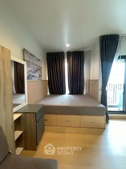 Modern bedroom with large windows and stylish wooden furniture