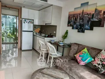 Cozy modern living room with open kitchen and cityscape wall art