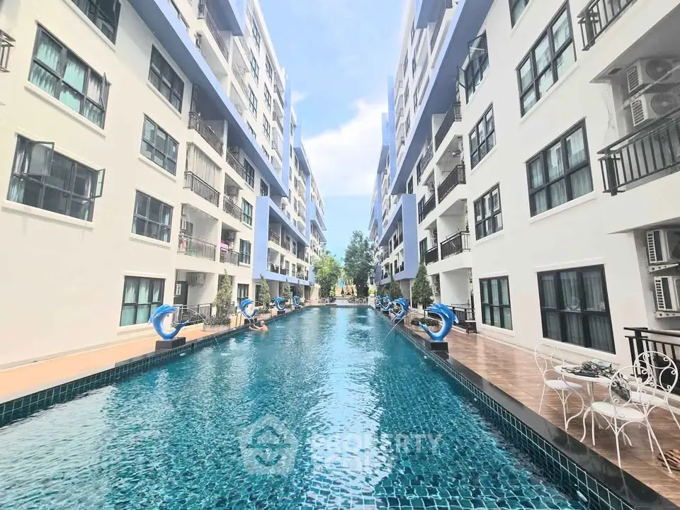Luxurious apartment complex with stunning pool and modern architecture.
