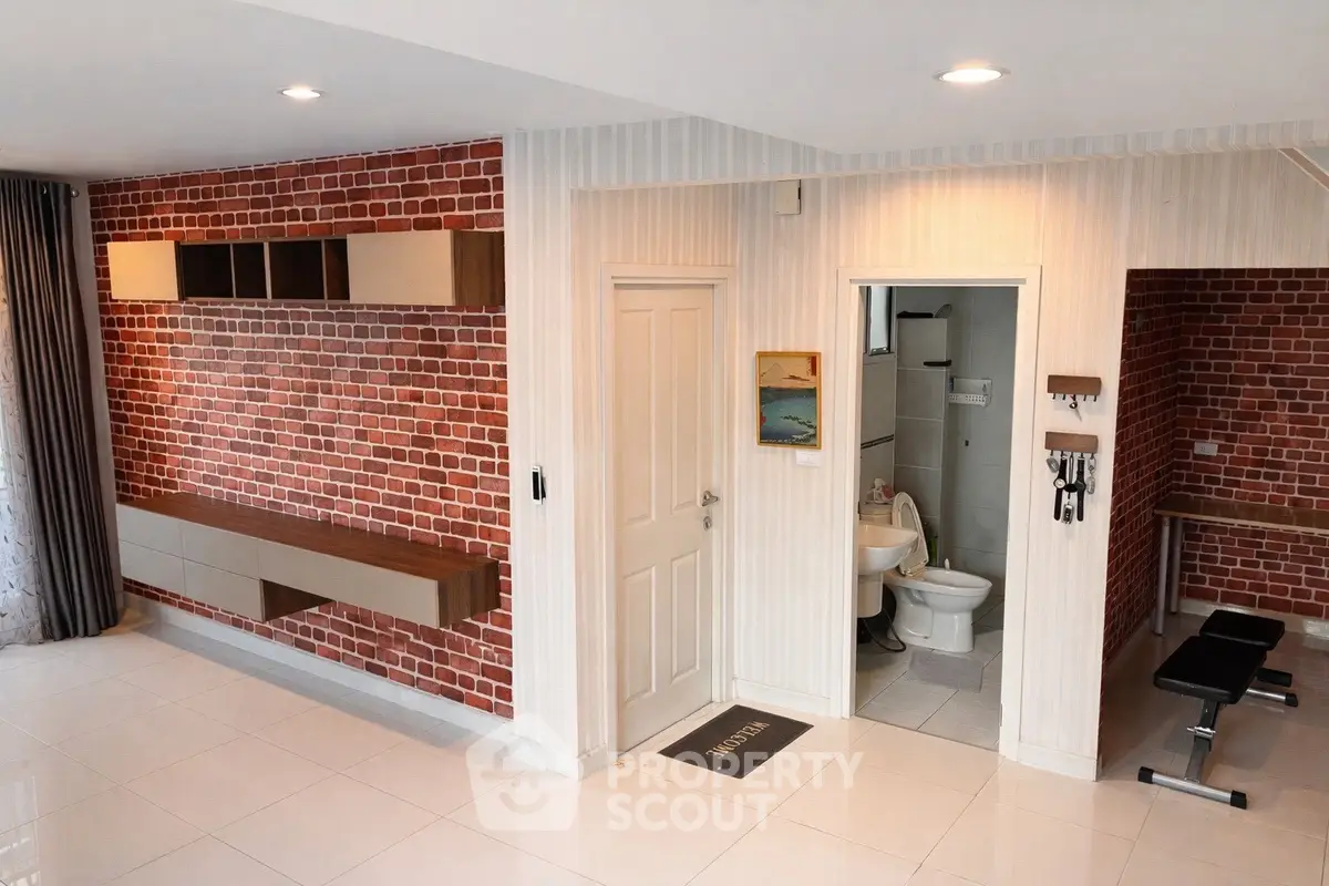 Modern interior with brick accent wall and home gym area