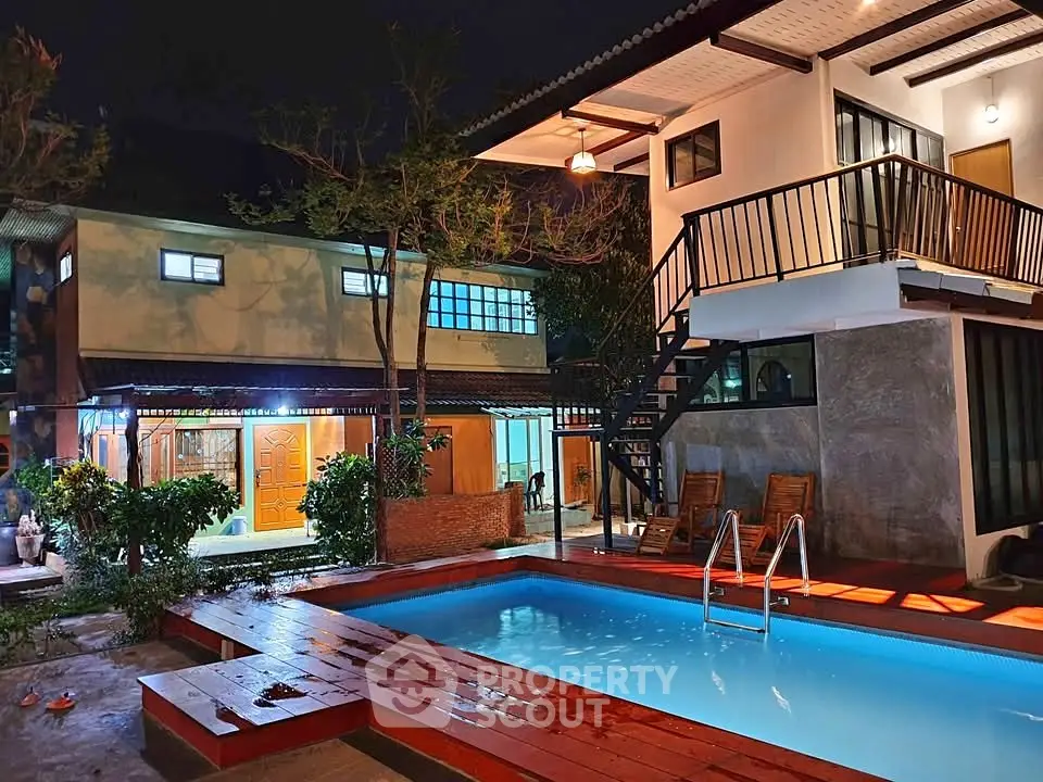 Stunning night view of modern home with illuminated pool and stylish architecture.