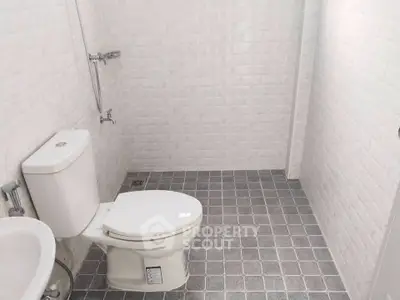 Modern minimalist bathroom with white brick walls and tiled floor
