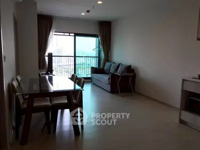 Spacious modern living room with dining area and city view balcony.
