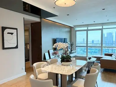 Luxurious living room with city view, elegant dining area, and modern decor in high-rise apartment.