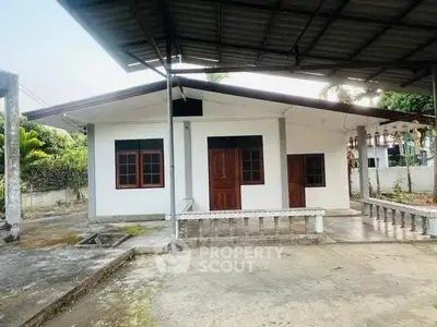 Charming single-story home with spacious front yard and covered patio area.