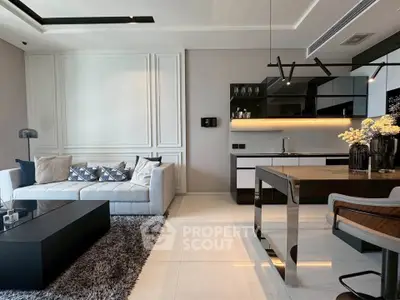 Luxurious modern living room with open kitchen, elegant decor, and sleek furniture design.