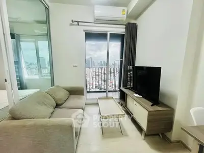 Modern living room with city view, cozy sofa, and sleek TV setup.