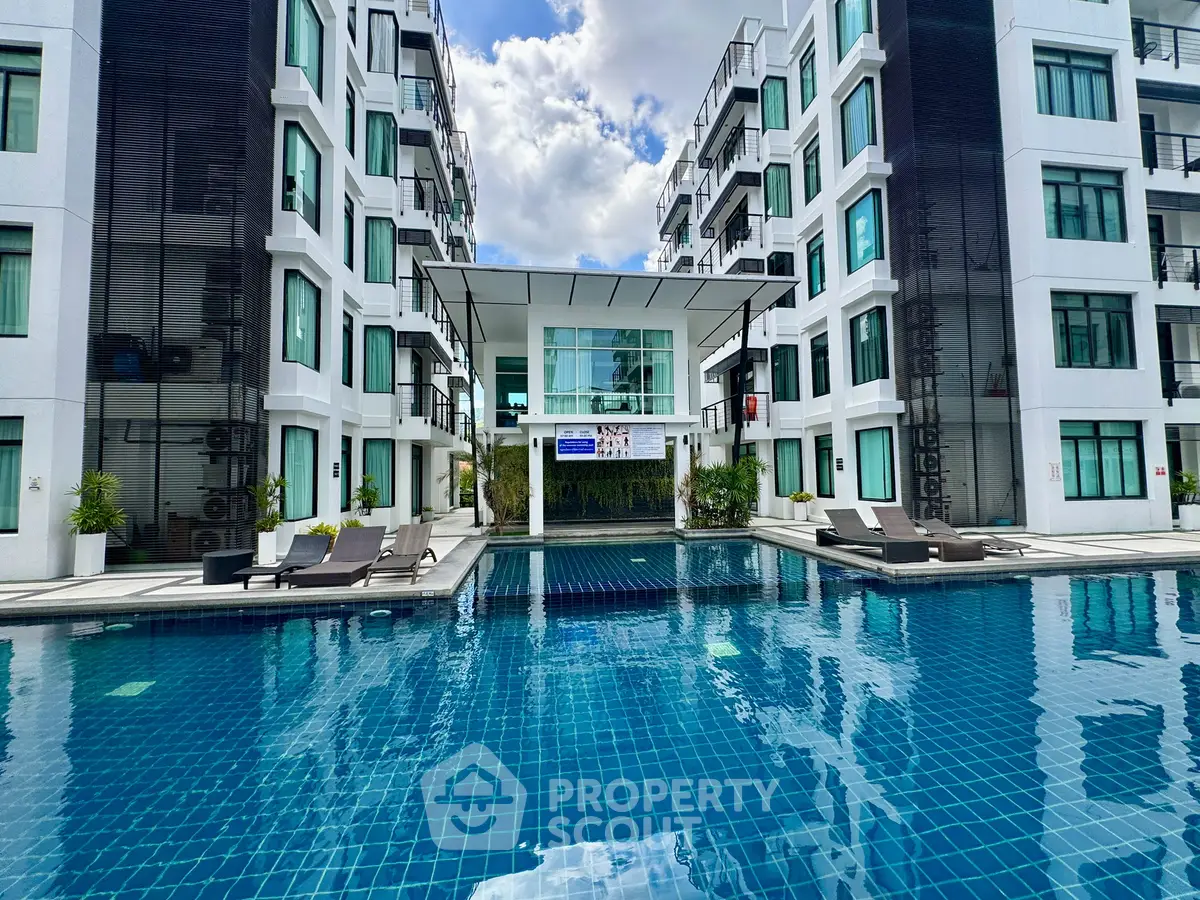 Luxurious modern apartment complex with a stunning pool and sleek architecture, perfect for upscale living.
