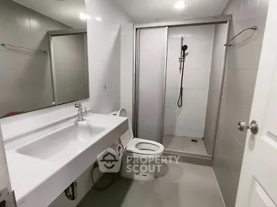 Modern bathroom with sleek fixtures and spacious shower area