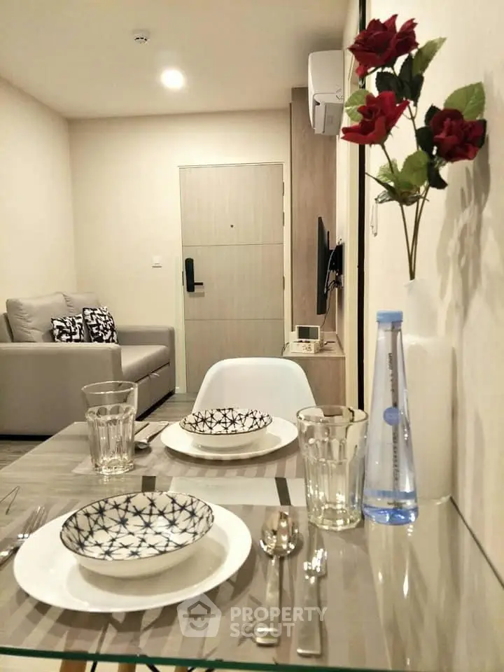Modern living room with elegant dining setup and cozy seating area, perfect for urban living.