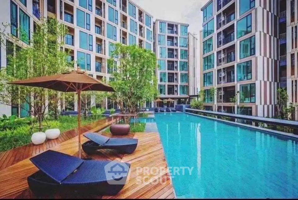 Luxurious modern apartment complex with stunning pool and lush greenery