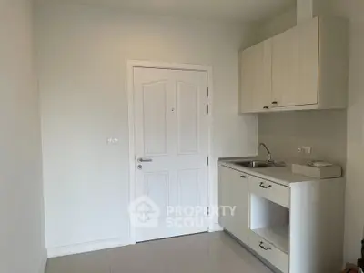Compact kitchen area with sink and storage in modern apartment