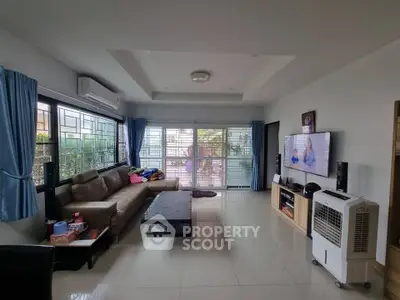 Spacious living room with modern decor and large windows for natural light.