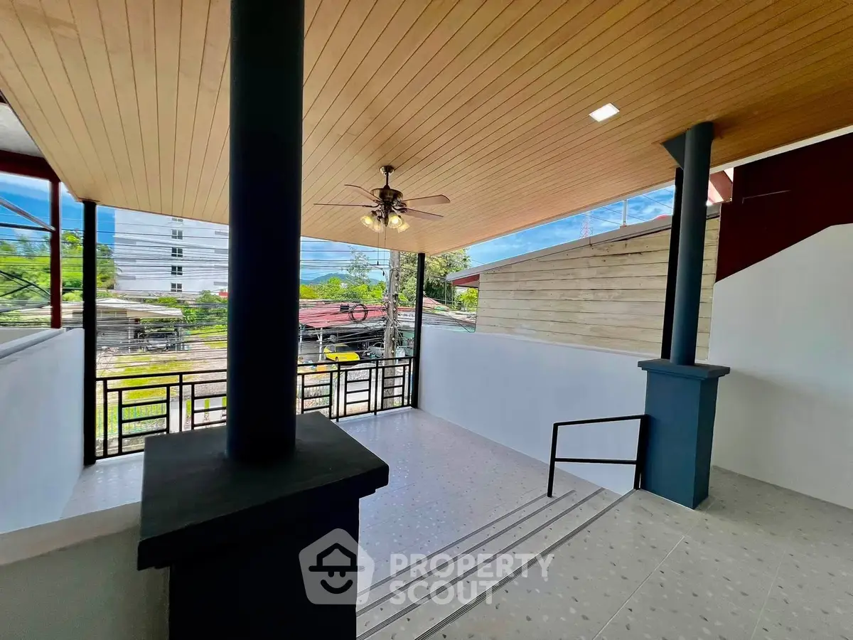 Spacious modern entrance with stylish ceiling fan and large windows offering natural light.