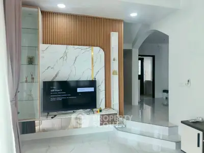 Modern living room with stylish TV unit and marble accents