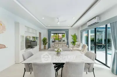 Spacious modern living room with elegant dining area and pool view