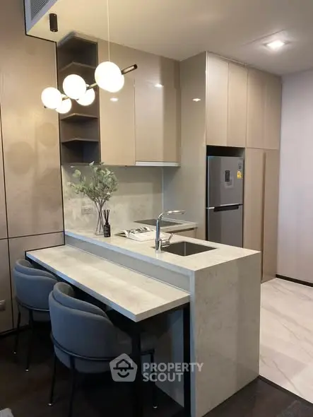 Modern kitchen with sleek cabinetry and breakfast bar seating