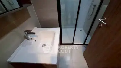 Modern bathroom with sleek sink and glass shower enclosure