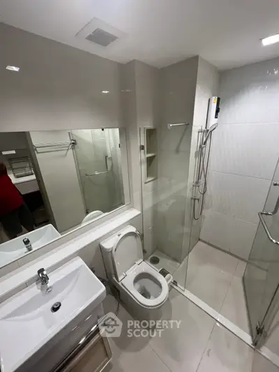 Modern bathroom with sleek fixtures and glass shower enclosure