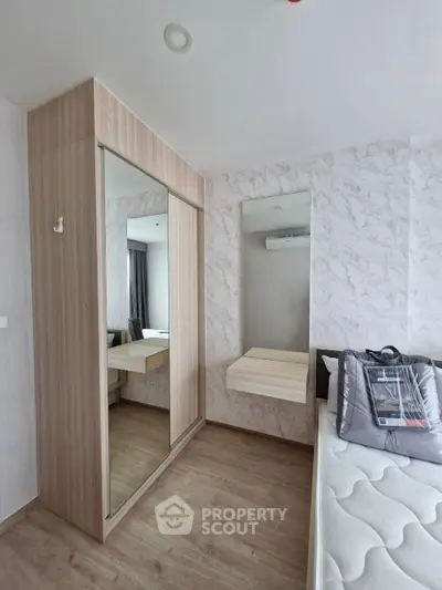Modern bedroom with mirrored wardrobe and minimalist decor