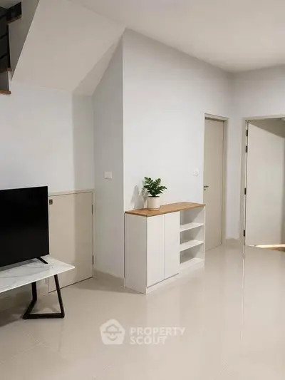 Modern minimalist living room with sleek furniture and neutral tones