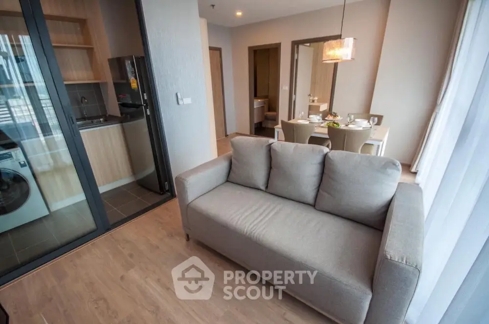 Modern apartment interior with open kitchen and cozy living area