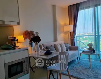 Charming modern living room with cozy decor and large window view