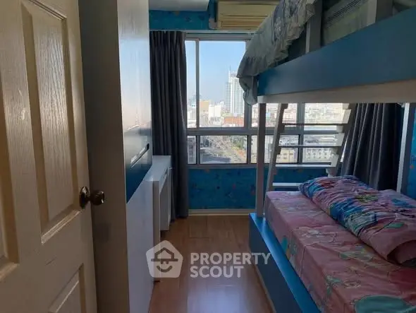 Charming bedroom with bunk beds and city view, perfect for kids or guests.
