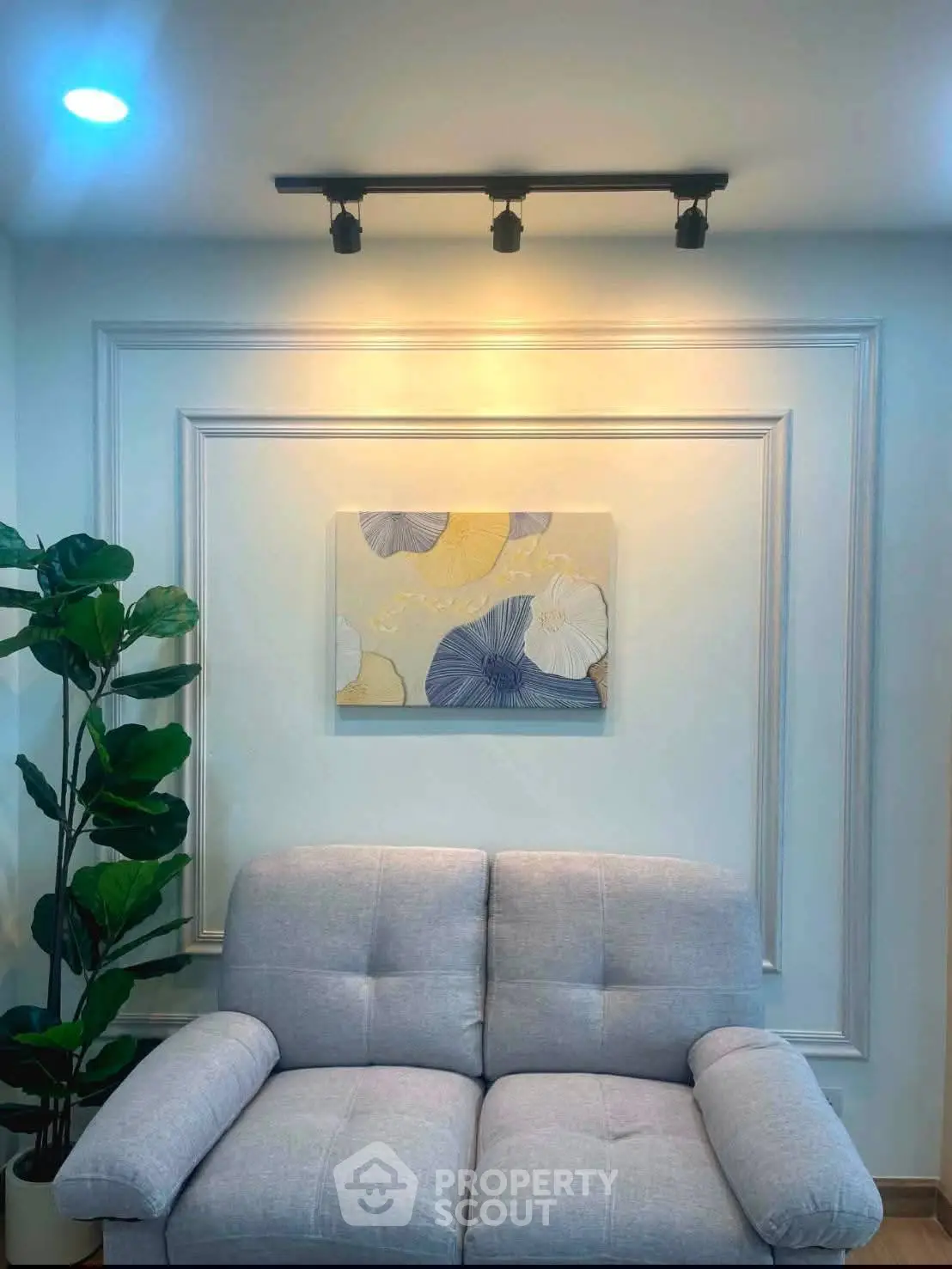 Stylish living room with modern sofa and elegant wall art, perfect for cozy relaxation.