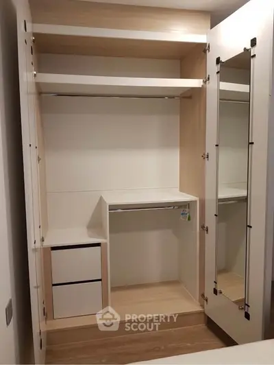 Spacious modern wardrobe with mirror door and ample storage space