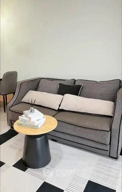Modern living room with stylish gray sofa and chic coffee table, perfect for contemporary urban living.