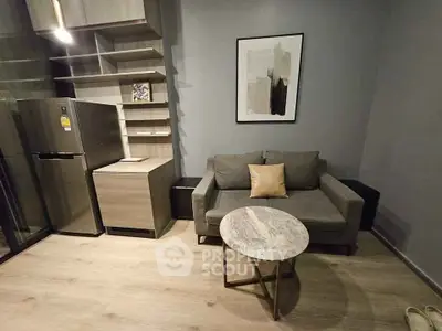 Modern living room with stylish furniture and sleek kitchen area