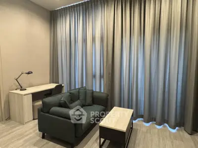 Modern living room with cozy sofa and study desk, perfect for work and relaxation.