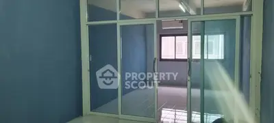 Spacious room with sliding glass doors and blue walls, ideal for versatile use.