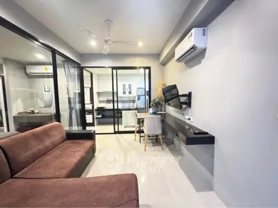 Modern living room with sleek furniture and open kitchen layout