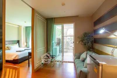 Modern apartment interior with cozy living room and bedroom, featuring stylish decor and natural light.