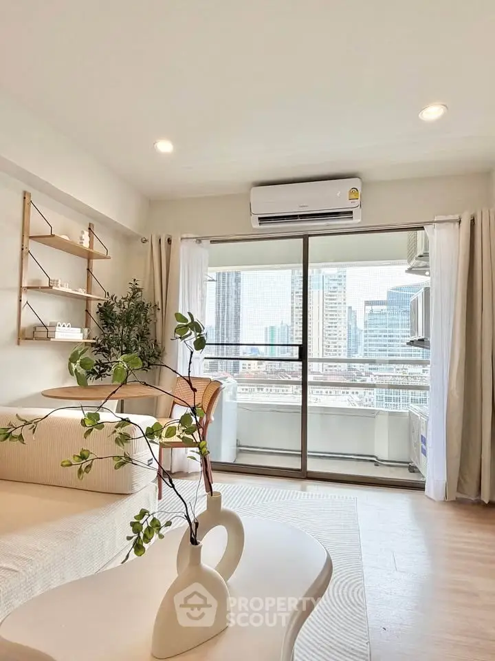Modern living room with city view, featuring elegant decor and natural light.