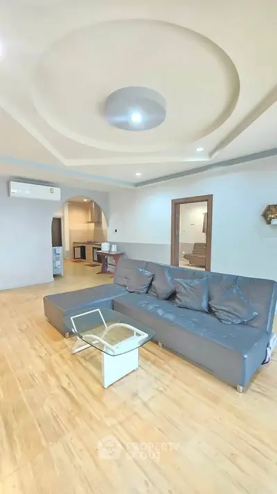 Spacious living room with modern sofa and stylish ceiling design