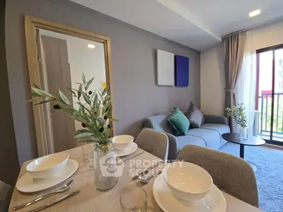 Modern living room with dining area and balcony view in stylish apartment.