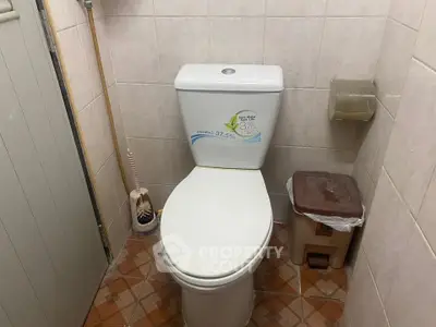 Compact bathroom with toilet and tiled floor, ideal for small spaces.