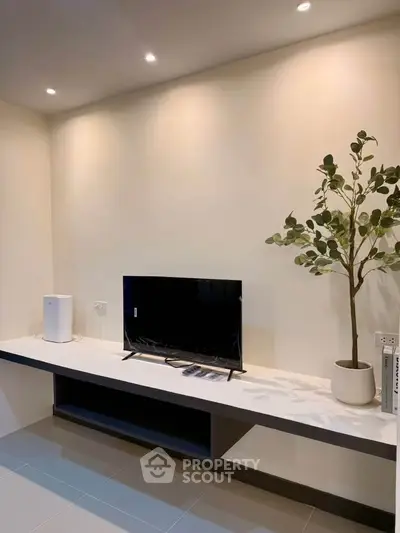 Modern minimalist living room with sleek TV setup and stylish decor