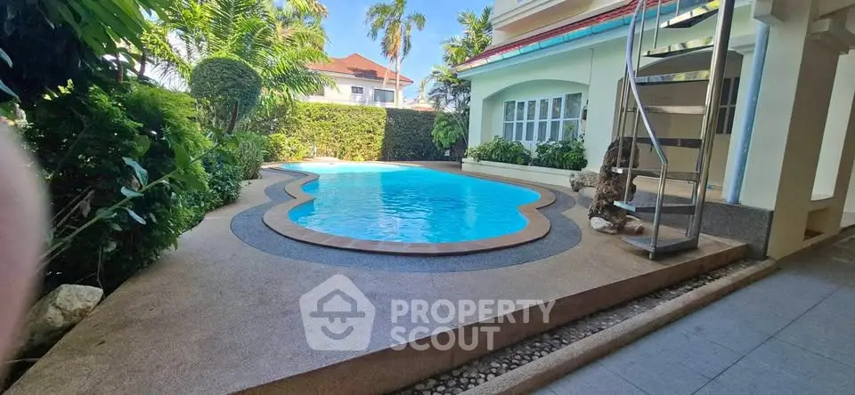 Luxurious private pool area with lush greenery and modern architecture, perfect for relaxation and entertainment.