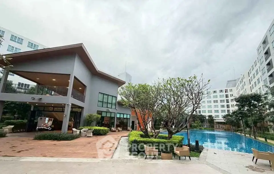 Modern residential complex with pool and lush landscaping