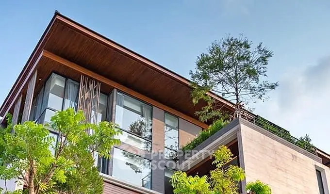 Modern architectural building with lush greenery and sleek design elements.