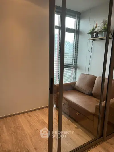 Cozy small living room with glass sliding door and modern decor