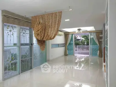 Spacious living room with large windows and modern decor