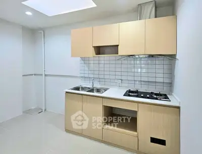 Modern kitchen with sleek cabinetry and gas stove in a minimalist design