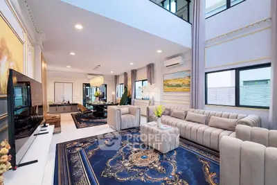 Luxurious living room with elegant decor, plush sofas, and a stunning chandelier, perfect for sophisticated gatherings.