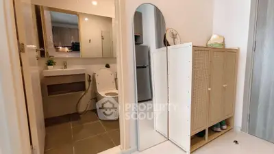 Modern apartment interior with bathroom and stylish storage solutions.