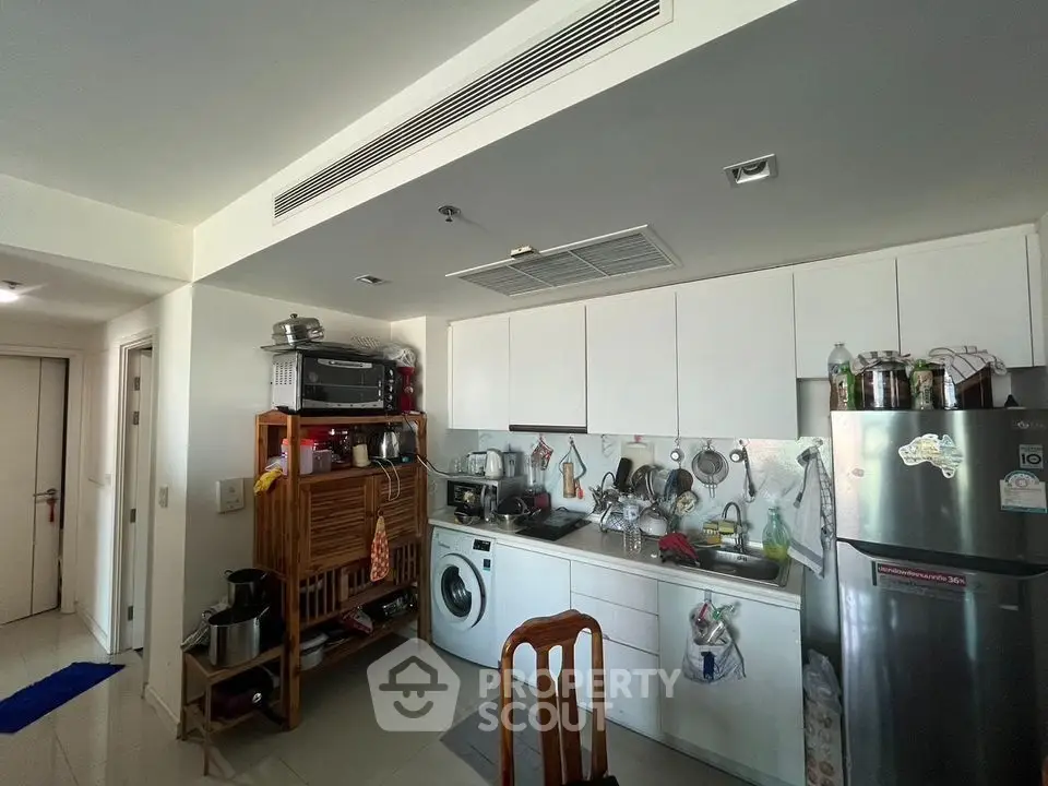 Cozy kitchen with modern appliances and washing machine in a compact layout